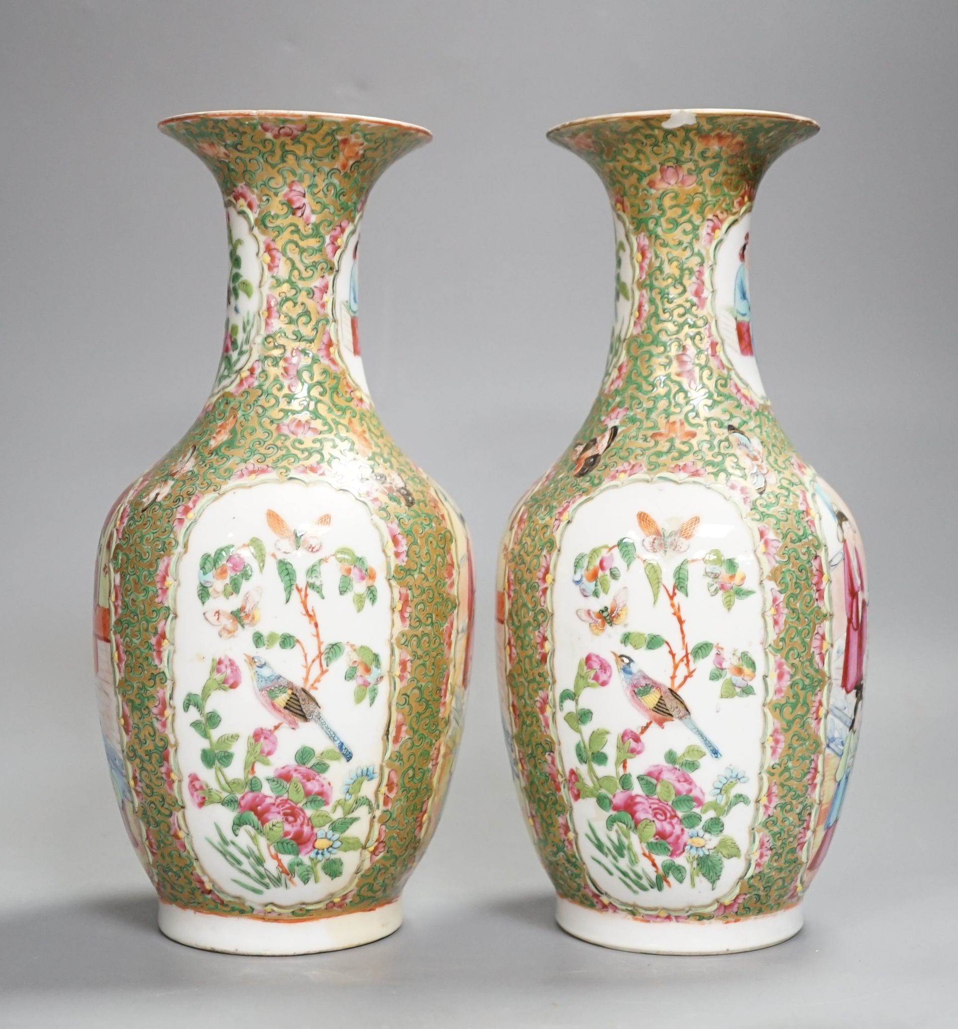 A pair of 19th century Chinese famille rose vases, 24 cms high.